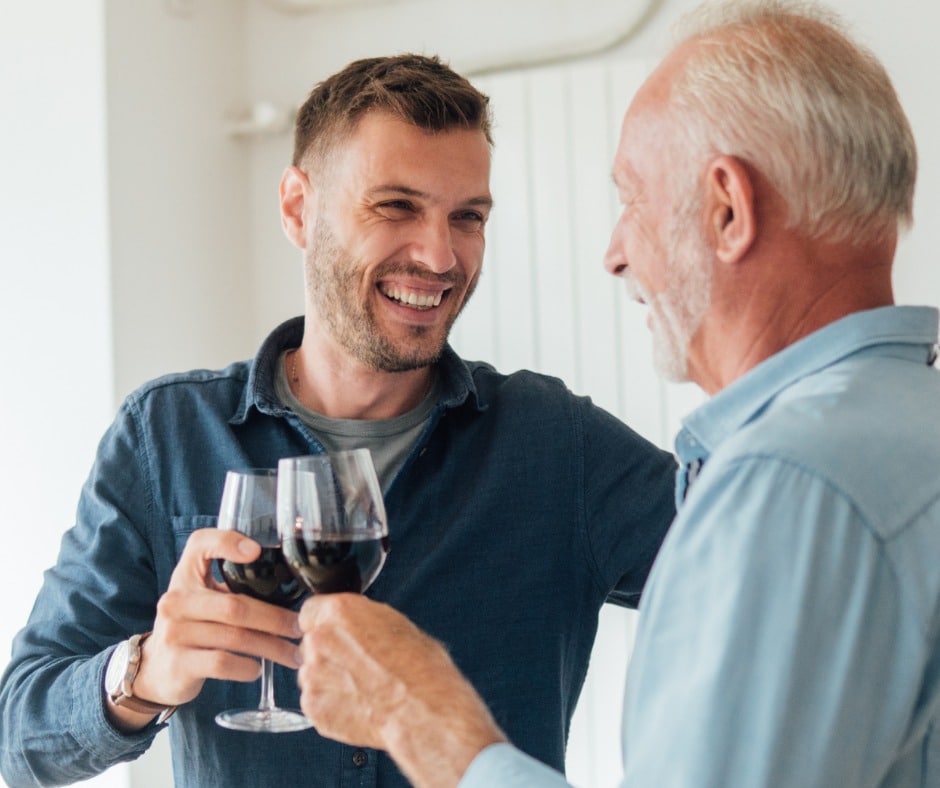 happy man hugging his father and having a wine picture id1033957070